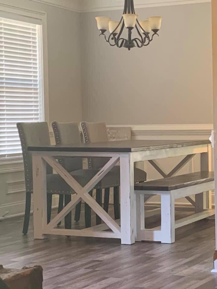 White farmhouse dining table with dark gray top, X legs and matching bench