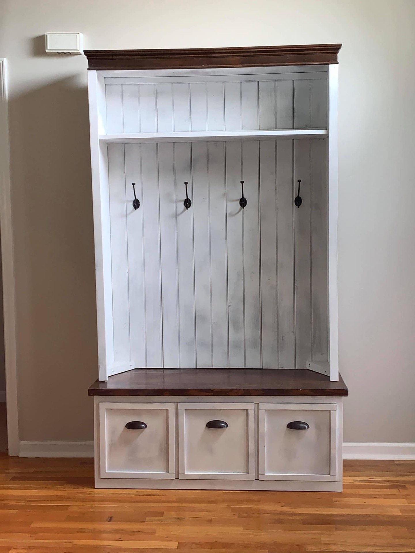 Freestanding white hall tree locker with hooks, bench and three storage drawers